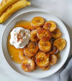 bananas and whipped cream on a white plate