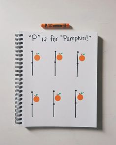 a spiral notebook with oranges on it and the words p is for pumpkin