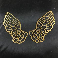 gold angel wings on a black background