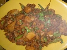 a yellow plate topped with meat and vegetables