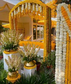 flowers and decorations in front of a yellow building