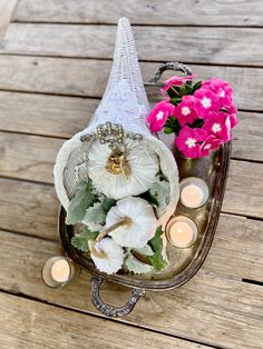 flowers and candles are sitting on a table