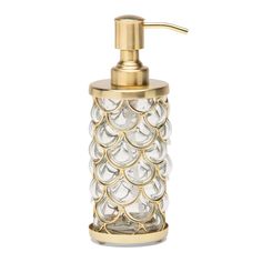 a gold and clear soap dispenser on a white background