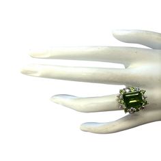 Stamped: 14K White GoldTotal Ring Weight: 6.5 GramsRing Length: N/ARing Width: N/AGemstone Weight: Total Natural Peridot Weight is 4.27 Carat (Measures: 11.06x8.87mm)Color: GreenDiamond Weight: Total Natural Diamond Weight is 0.70 CaratColor: F-G, Clarity: VS2-SI1Face Measures: 18.42x16.83 mmSku: [702688W] Multi-stone Emerald Ring For Formal Occasions In May, Multi-stone Emerald Ring For Formal May Birthstone, Heirloom Emerald Ring With Gemstone Accents For Formal Events, Art Deco Green Emerald Multi-stone Ring, Estate Style Formal Rings With Gemstones, Antique Green Diamond Ring With Center Stone, Formal Tsavorite Rings With Accent Stones, Art Deco Green Diamond Ring Hallmarked, Heirloom Green Ring With Gemstone Accents