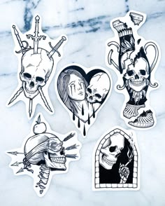 four stickers with different designs on them, one is skull and the other has a heart