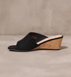 Getting closer everyday. A sleek silhouette by Mi.iM, these slip-on wedges are a versatile favorite. With a shallow heel and an open toe design, these heels can be pair with a sundress for a day look, or an LBD for a night out. Manmade Upper l Genuine Leather Insole l 2.5" Heel l True to Size Summer Wedge Heels With Wooden Heel, Summer Heels With Wooden Wedge Heel, Summer Wedge Sandals With Wooden Heel, Modern Synthetic Wedge Sandals With Wooden Heel, Chic Slip-on Wedge Heel Sandals, Slip-on Platform Wedge Sandals, Summer Wedge Mules With Padded Heel, Summer Wedge Heel Mules With Cushioned Footbed, Summer Mules With Padded Wedge Heel