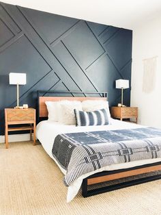 a bedroom with a large bed and two nightstands on either side of the bed