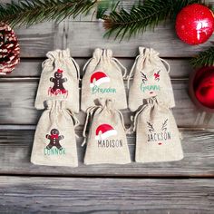 six bags with christmas designs on them sitting next to ornaments