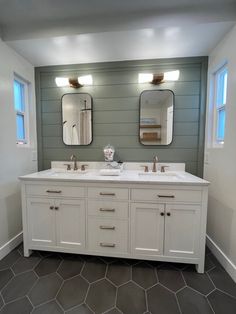 a bathroom with two sinks and mirrors on the wall above them is shown in an empty room