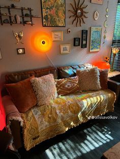 a living room filled with furniture and pictures on the wall