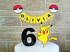 a pokemon birthday cake with the number six on it and two pikachu decorations