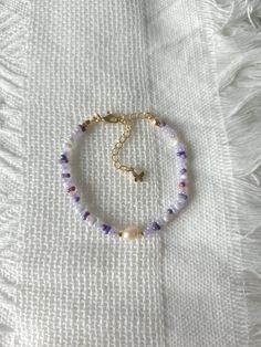 FOR OTHER DAINTY BEADED BRACELETS: https://www.etsy.com/ca/shop/ArtiChouXCanada?ref=seller-platform-mcnav§ion_id=46088511 Bracelet Length: 13-18cm (5.1-7 inches) with a 14k gold filled extender.  This bracelet features an assortment of mysterious purple toned colors: purple, violet, white, and 18k gold filled seed beads. It also contains a freshwater pearl.  Thread may be visible since it is a handmade product   SIZING  Wrap a soft measuring tape snugly around the widest part of your wrist. Add 1.27cm (0.5in) to that measurement to determine the right bracelet size.  MATERIALS  - Japanese MGB glass seed beads(2x4mm) - 18K gold filled beads of 2mm - Freshwater pearl - 14K gold filled extender  CARE INSTRUCTIONS   To maintain its radiance, gently clean the bracelet with a soft cloth and stor Adjustable Purple Bracelet With Tiny Beads, Purple Beaded Pearl Bracelet For Gift, Purple Beaded Pearl Bracelets, Dainty Purple Beaded Bracelet, Purple Beaded Pearl Bracelet, Freshwater Pearl Bracelet, Beaded Accessories, Seed Bead Bracelets, Bracelet Sizes