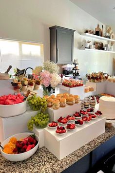 a table filled with lots of different types of food on top of white plates and bowls