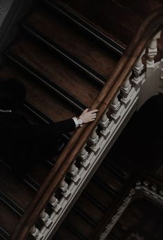 a man in a tuxedo is standing on the stairs