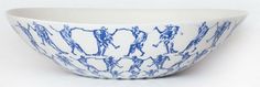 a blue and white bowl with horses on it