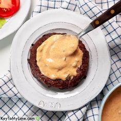 a plate with some food on it and a fork in the bowl next to it