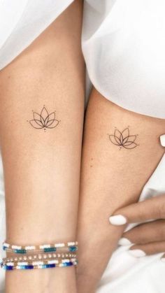 two women with matching tattoos on their legs