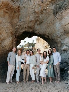 a group of people standing in front of a cave