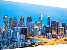 the city skyline is lit up at night in this panoramic photo from across the river