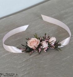 a pink rose and white ribbon flower headband