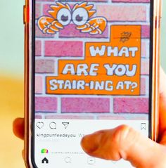 someone is holding up their cell phone to show what are you stairing at?