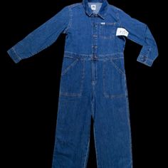 Made From 100% Cotton. Medium Wash. Button Down Style Front. Adjustable Waist. Front Pockets. Blue Cotton Button-up Denim Jumpsuit, Denim Jumpsuit With Bib Front For Workwear, Casual Blue Workwear Shortalls, Casual Blue Shortalls For Work, Dark Wash Denim Bib Front Jumpsuit For Work, Utility Overalls With Button Closure And Relaxed Fit, Dark Wash Denim Jumpsuit For Workwear With Bib Front, Denim Bib Front Jumpsuit For Work, Dark Wash Denim Jumpsuit For Work