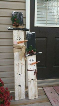 two snowmen made out of wood sticks