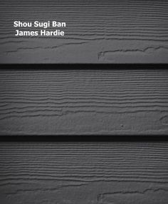 the side of a wooden building with black siding and white text that reads shou sugi ban james hardie