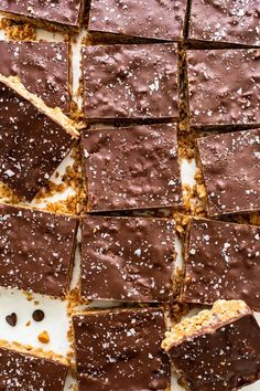 there are many pieces of chocolate cake on the plate and one is cut into squares