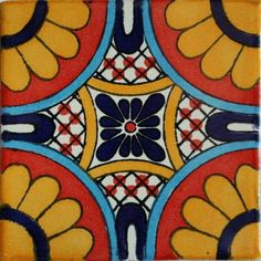 an artistic tile design in red, yellow and blue with flowers on the bottom corner