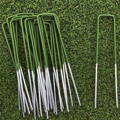 several green and white metal tongs laying on the grass