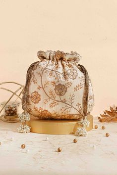 Colour: Cream Embroidered front and back. Dimensions (LxB): 9.5" x 9" (24 cm x 23 cm) Handle drop: 5" (13 cm) Material : Embroidered poly silk, poly satin lining, woven golden thread drawstrings and handle, scallop lace and pearl tassels. Traditional Potli Bag With Dori Work For Reception, Festive Multicolor Embroidered Handwork Potli Bag, Zari Work Potli Bag For Festivals And Reception, Festival Reception Potli Bag With Zari Work, Festive Multicolor Embroidered Potli Bag With Handwork, Traditional Festive Potli Bag For Reception, Multicolor Embroidered Potli Bag With Handwork For Festivals, Festive Zari Work Potli Bag For Reception, Elegant Multicolor Embroidered Potli Bag For Festivals