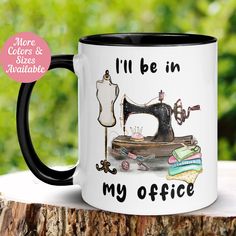 a coffee mug that says i'll be in my office next to a sewing machine