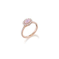 a pink diamond ring on a white background