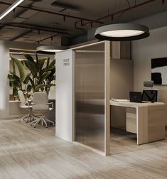 an office cubicle with desks, chairs and plants on the walls in front of it