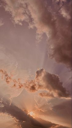 an airplane flying in the sky at sunset