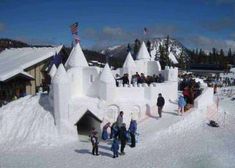 people are standing in front of an ice castle