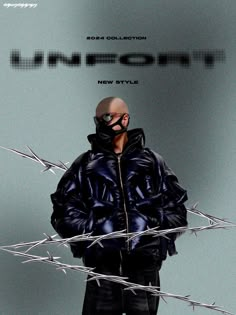 a man standing in front of barbed wire and wearing a black jacket with the word urban on it