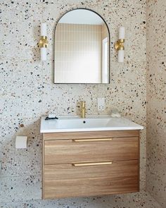 a bathroom vanity with a mirror above it