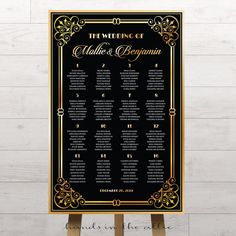 a black and gold wedding seating chart on a wooden easel with white wood flooring