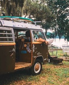 an old van is parked in the grass