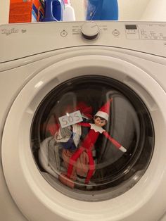 an elf on top of a washing machine