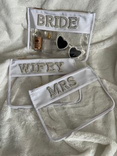 the bride and groom's personal items are laid out on a white bed sheet