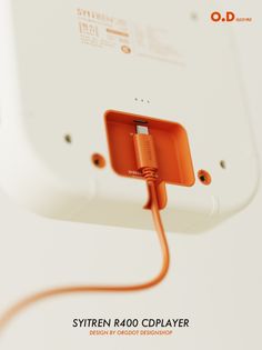 an orange cord connected to the back of a white device