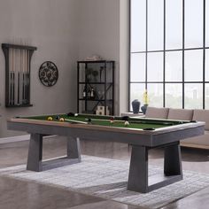 a pool table in the middle of a living room