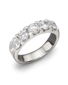 a white gold ring with five diamonds