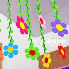 some paper flowers hanging from the ceiling