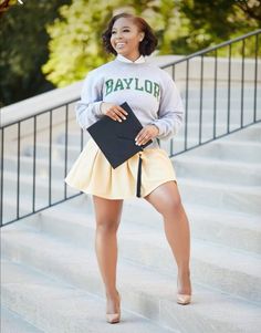 a woman is standing on some steps with her skirt in front of her and smiling at the camera