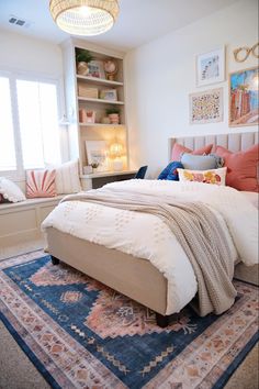 a bedroom with a large bed and lots of pillows