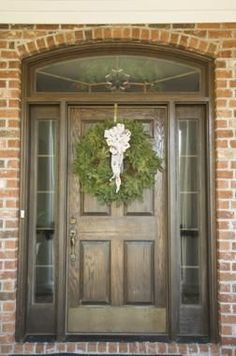 a wooden door with a wreath on it